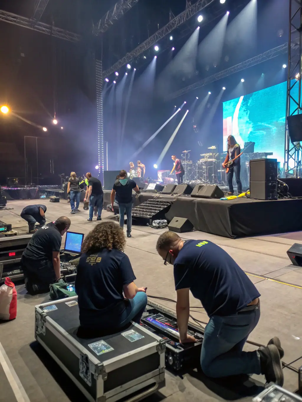 A group of volunteers setting up for an outdoor music event, demonstrating community involvement with Ca Sonne Terrible.
